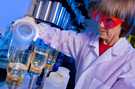 A CDC microbiologist pours water samples