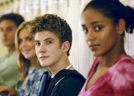 Students sitting in front of lockers