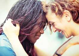 Mixed race girlfriends enjoying to stay together, outdoors.