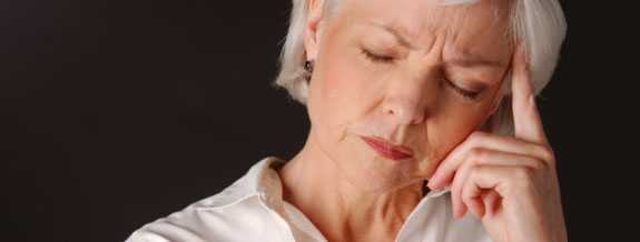 woman holding her temple as if she has a headache