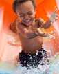 	boy on water slide going into water