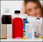 Woman looking at several bottles of medicine