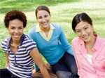 Three woman sitting on grass