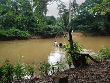 CDC RITE team members ride in a dugout canoe during their journey to Geleyansiesu<strong>,</strong> Liberia, a rural village with reported Ebola cases.