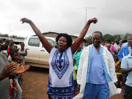 	Ebola survivor, accompanied by medical director, being welcomed by her community - Firestone District, Liberia, 2014