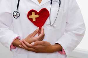 Physician with a felt heart in his hands