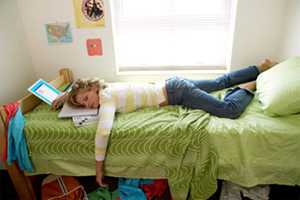 Teen sleeping on her bed