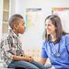 A young boy with a school nurse