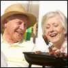 Photo: An older couple grilling hot dogs