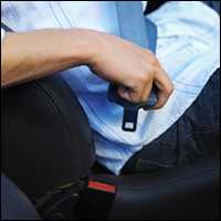 A person buckling their seat belt