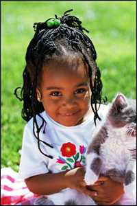 Young girl holding a kitten