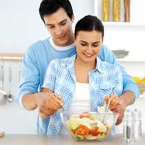 Man and woman tossing a salad