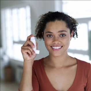 Woman with an inhaling device