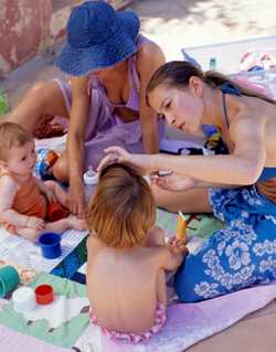 Photo: Mother applying suncreen to her child