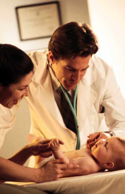 Photo: Physician examining an infant