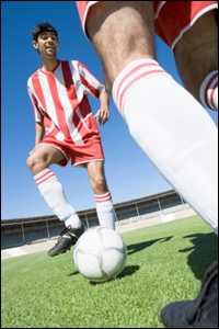 Two men playing soccer