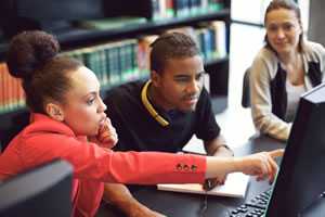 	diverse young adults working on computer