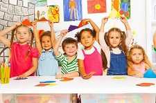 The figure above is a photograph showing a group of children in a classroom.