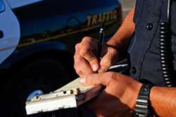 Policeman writing a traffic ticket