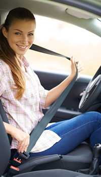 photo: girl putting on a seatbelt