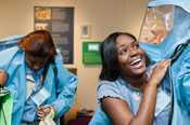 Students try on the Biosafety Level 4 lab suits.