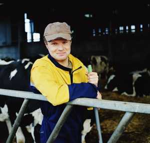 Farmer leaning on fence