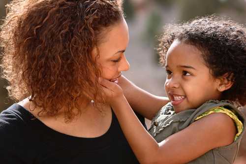 Daughter with here hands on her mom's face