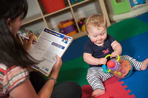 Mom using checklist with baby 9 mo