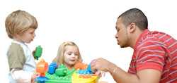 Man playing blocks with children