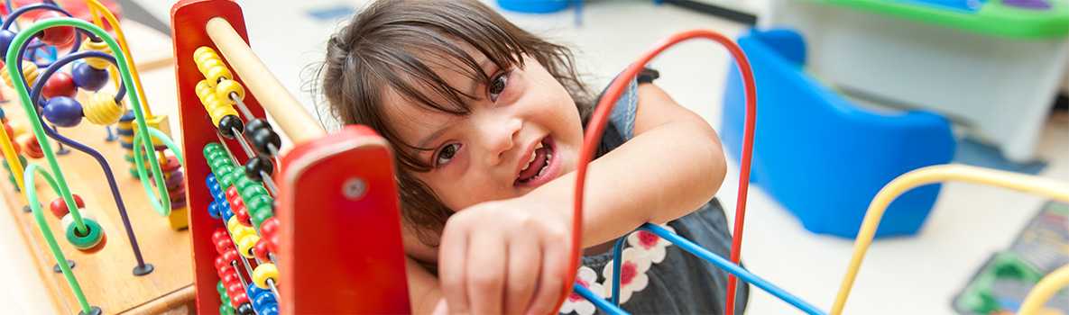 Boy playing with a wooden slider