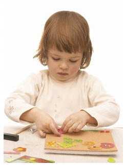 Photo: Child playing with puzzle