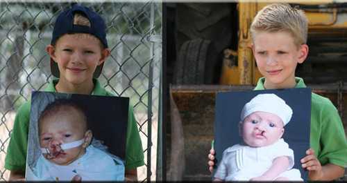 Daniel and Jacob holding pictuers of themselves as infants