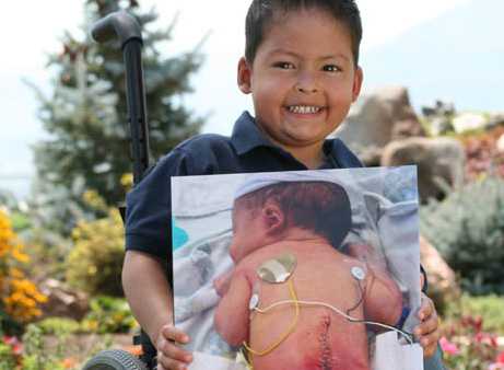 Zach holding a picture of him as an infant.