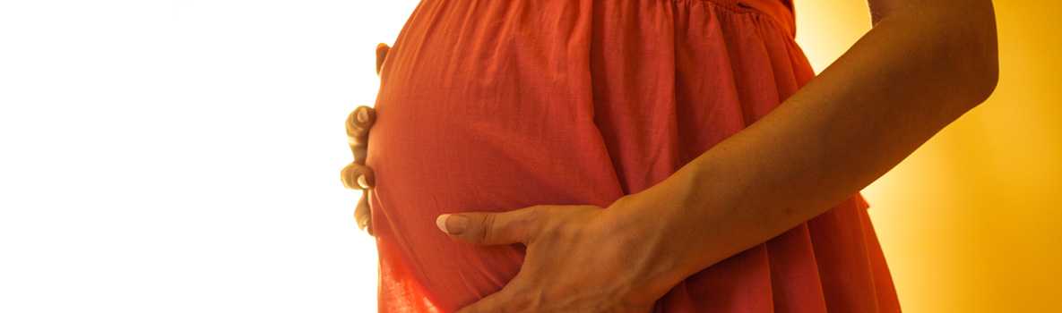 Pregnant woman in an orange dress