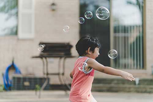 A child playing with bubbles