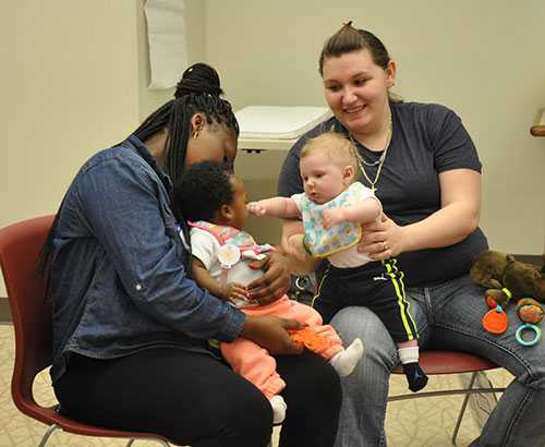 Two mothers with their babies