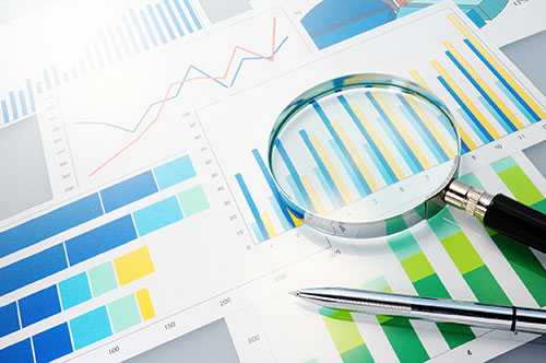 Data research graphs with a magnifying glass 