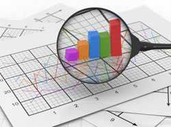 magnifying glass with spreadsheets