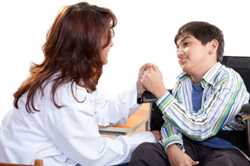 physician with boy in wheelchair