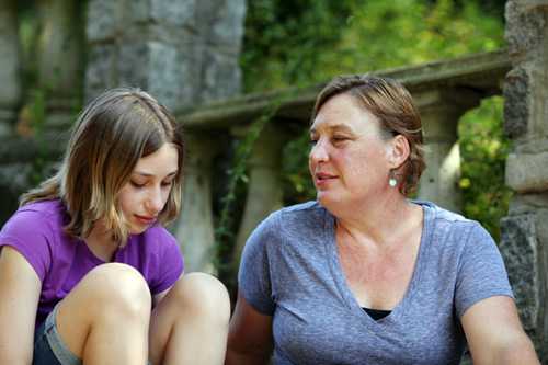 A young girl talking with her mother.