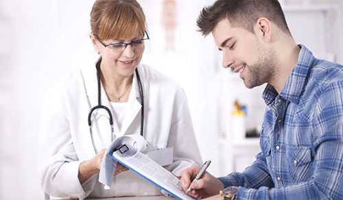 Doctor with patient filling out information. 