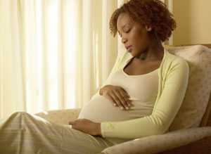 Pregnant woman sitting in a chair