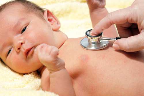 Doctor listening to a baby's heart