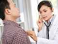 Doctor listening to a male patient's heart