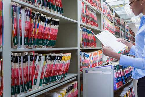 Photo of healthcare admin reviewing files