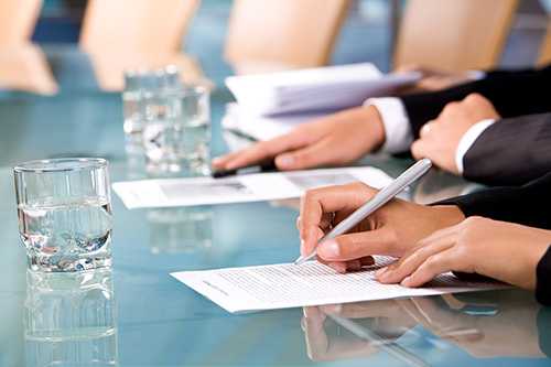 Business people writing in a conference room