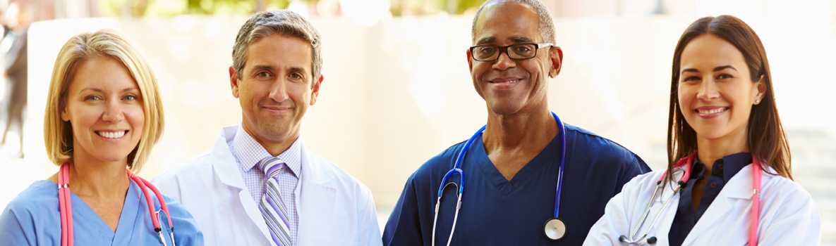 Group of doctors posing for picture outdoors