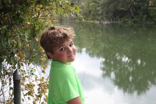 Boy beside riverbank