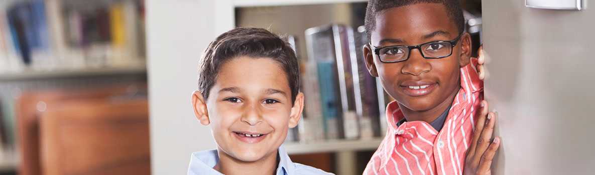 Two smiling boys in the library