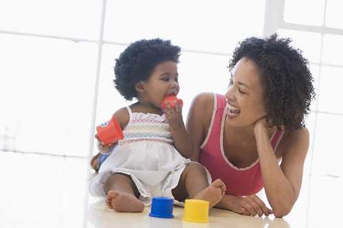 Mother and daughter playing with blocks